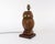 A very weighty near-antique owl-shaped table lamp made of carved oak, with an exotic hardwood base, both with a lustrous...