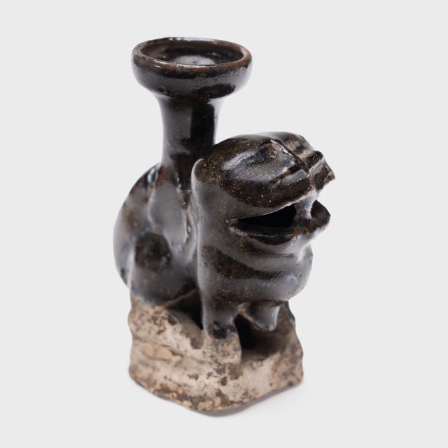 Richly aged with wabi-sabi texture, this petite ceramic sculpture is a 19th-century Chinese candle stand molded in the...