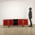 Sideboard with hinged doors, attributed to the designer Sergio Mazza, the furniture is in exotic wood veneer, with fabric...