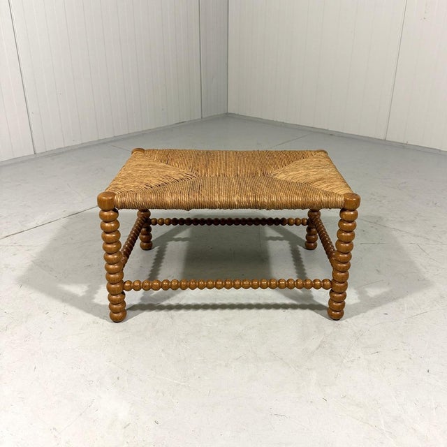 Lovely low bobbin stool. Blond oak frame in bobbin shape, rushed seat. Nice to use as sidetable for magazines, plaids or...