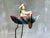 Whimsical vintage balancing sailor toy with hand-painted metal boat, articulated rowing mechanism, and poetic nautical...