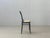 Elegant vintage bentwood chair with a black wooden frame and a light-colored cane seat. The curved design is inspired by...