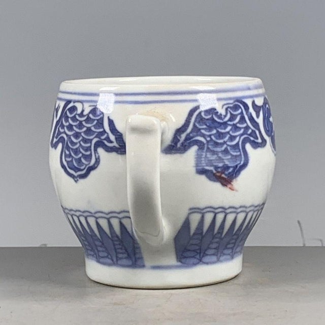 This is a charming vintage porcelain cup, decorated in the classic blue and white (青花) palette with hand-painted details....