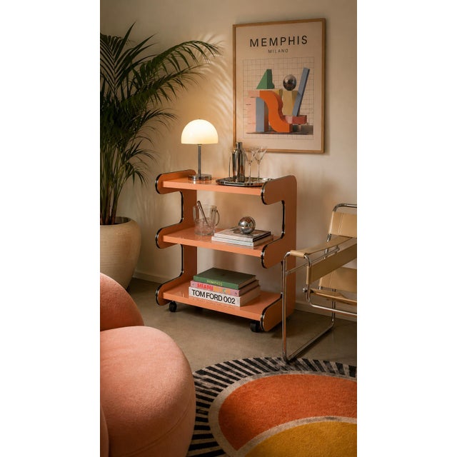 Bring iconic 1980s Postmodern design into your space with this sculptural rolling bar cart or display shelf. Crafted in a...