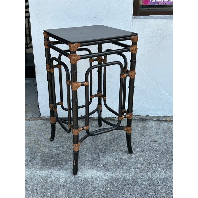 Boho chic pair of stands or tables crafted in wood in a faux bamboo technique with Rattan highlights. Sign on a label...