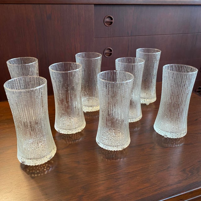 This set of eight vintage drinking glasses features the iconic "Ultima Thule" pattern designed by Tapio Wirkkala for...