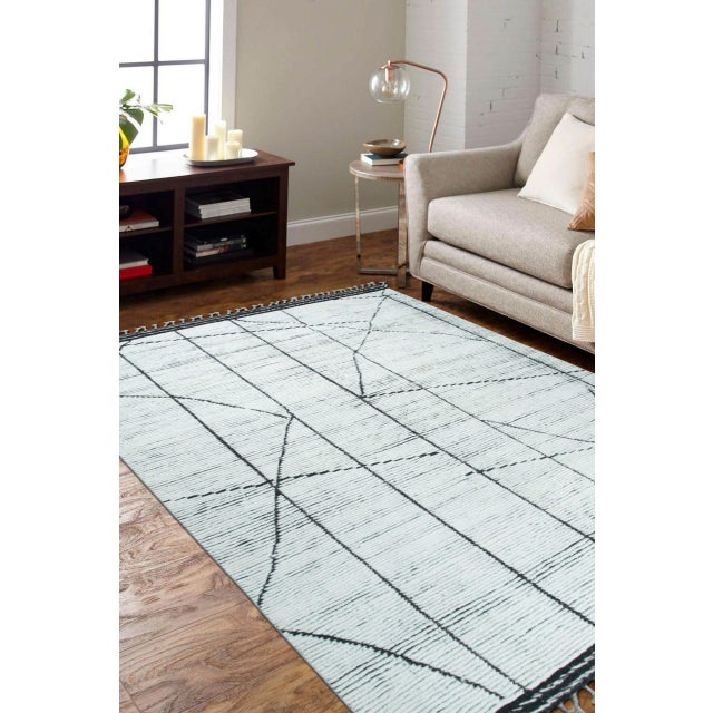 Refined Marrakech Ivory Hand-Knotted Wool Berber Carpet, Country of Origin: Pakistan. This exquisite piece offers a...