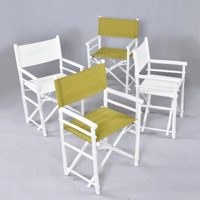 Pair of recently restored white and green rattan director’s chairs. Made in Vietnam. The white enamel paint finish looks...