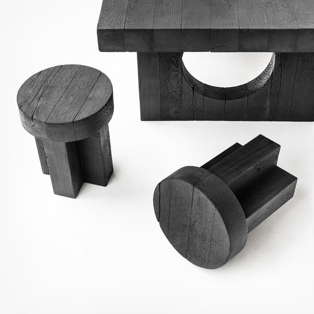 The Kurai Collection consists of a solid Padouk dining table, two benches and two stools finished with the Shou Sugi Ban...
