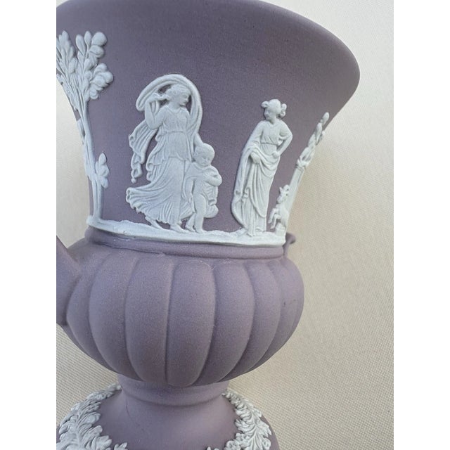 Showcasing timeless beauty and classic craftsmanship, this Wedgwood Jasperware Grecian vase features a lovely lilac...