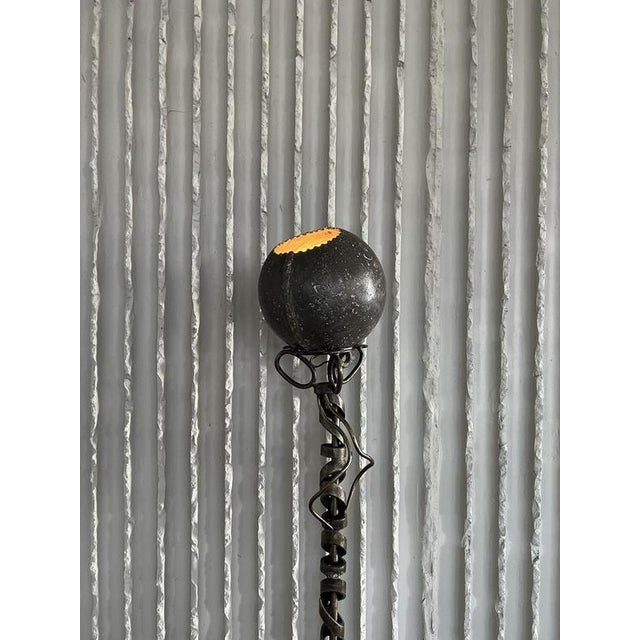 An exceptional handmade french arts & crafts floor lamp, crafted from forged steel with a striking sculptural silhouette....