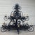 Enormous black, wrought iron chandelier fit for the entryway or kitchen of a queen. The chandelier has two tiers that are...