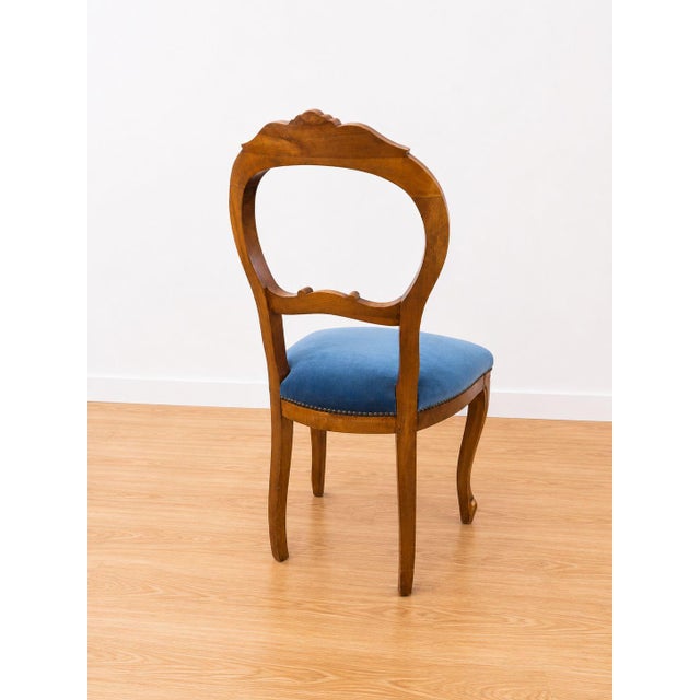 An elegant set of five 1950s chairs. The frame is made entirely of walnut, finely carved with floral motifs on the top of...