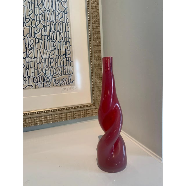 A twisted art glass vase - a compliment in decor on any table or shelf with or without the addition of your favorite stem...