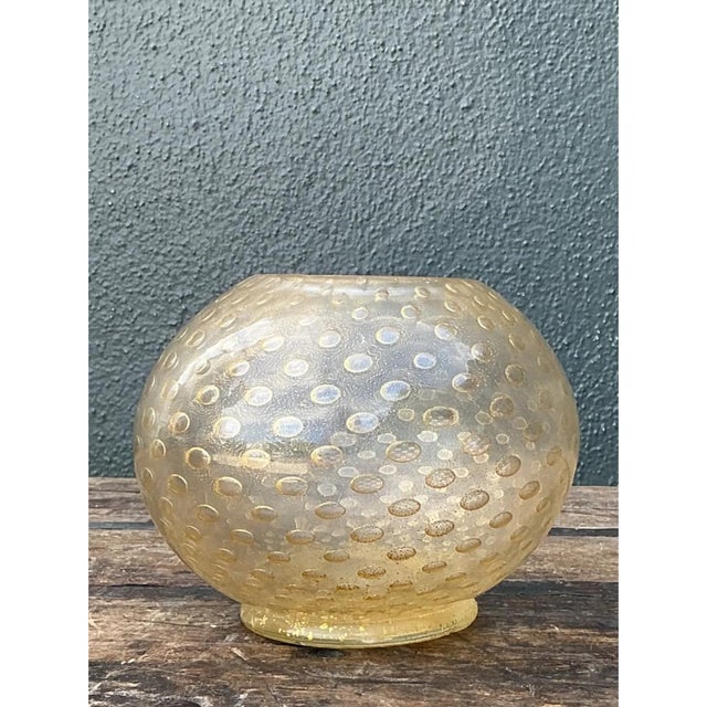 This vintage spherical glass bowl exemplifies the celebrated bullicante technique associated with Murano glasswork, its...