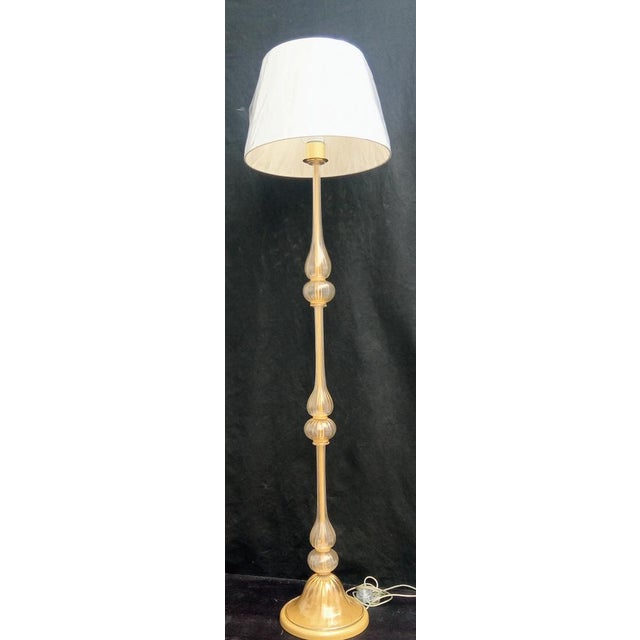 Floor lamp in hand-blown and hand-crafted Murano glass, transparent gold leaf colour, gold painted metal structure....