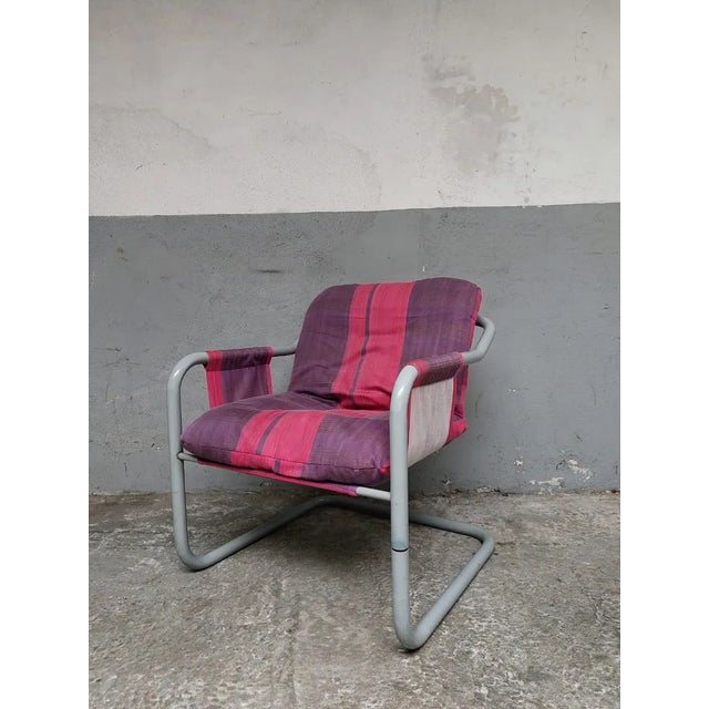 The chair is in good condition. There are some signs of wear on the metal. This piece is attributed to the mentioned...