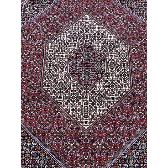 Persian Bijar rug, hand-knotted in Iran from 100% wool. Measuring 5’ x 8’, the rug features a traditional Herati-style...