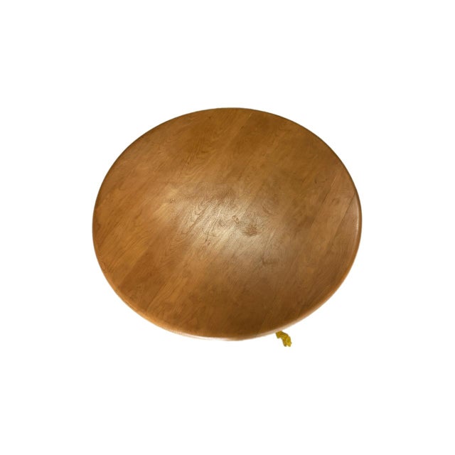 A very well crafted solid maple wood coffee table with revolving top sitting on sculptural legs manufactured by the...