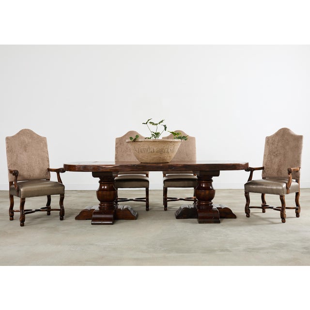 Grand set of fourteen bespoke walnut dining chairs designed in the opulent baroque Louis XIII taste. The chairs feature...