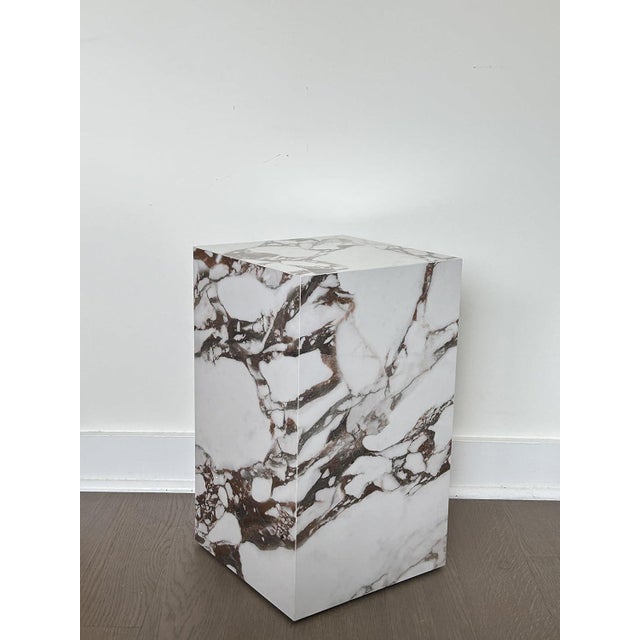 This stunning side table is inspired from premium Calacatta Viola marble, showcasing its iconic white base with dramatic,...