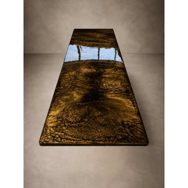 A table with a strong visual impact, conceived as an abstract surface where depth, light, and matter blend into a unique...