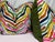 Custom pair of 22" pillows covered in a multi colored, embroidered zebra patterned fabric on a white linen fabric and...