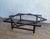 Large coffee table with a black-stained iron base in the shape of a star, topped with a round green onyx tabletop. The...