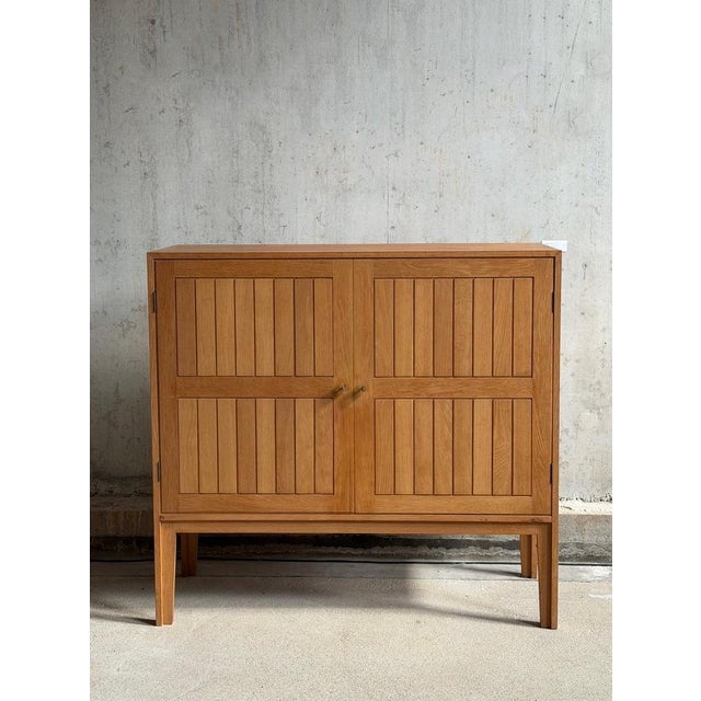 Cabinet in oak designed by Kurt Østervig for Vamo møbelfabrik, Denamrk 1960's. This beautiful cabinet features two doors...