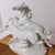Elegant and dynamic, this vintage porcelain sculpture by Carl Scheidig captures a pair of horses mid-gallop with striking...