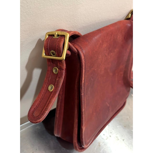 Vintage 1970s-80s Coach rare red leather cross-body purse or shoulder bag w/ adjustable buckle strap. Some mild wear to...