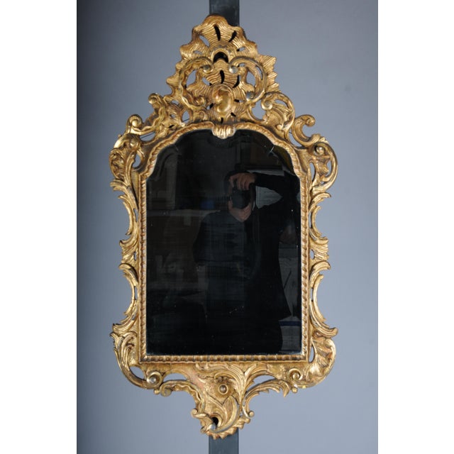 Venetian Baroque Wall Mirror, Ornately Gilded, 19th Century The frame is made of hand-carved wood, finished with gold...