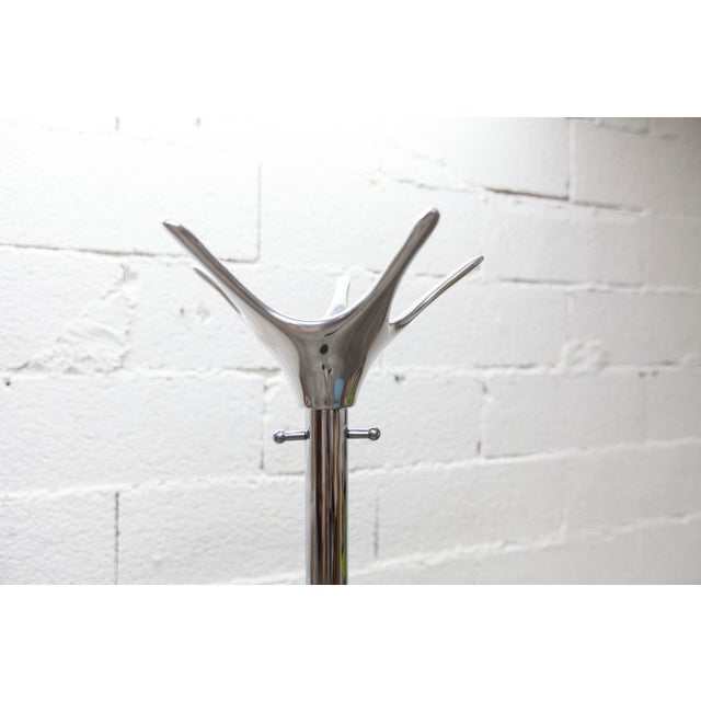 Cascando Tango coat rack designed by Minke Van Voorthuizen; Cast iron base, chromed stainless steel tube, and a top ring...