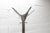 Cascando Tango coat rack designed by Minke Van Voorthuizen; Cast iron base, chromed stainless steel tube, and a top ring...