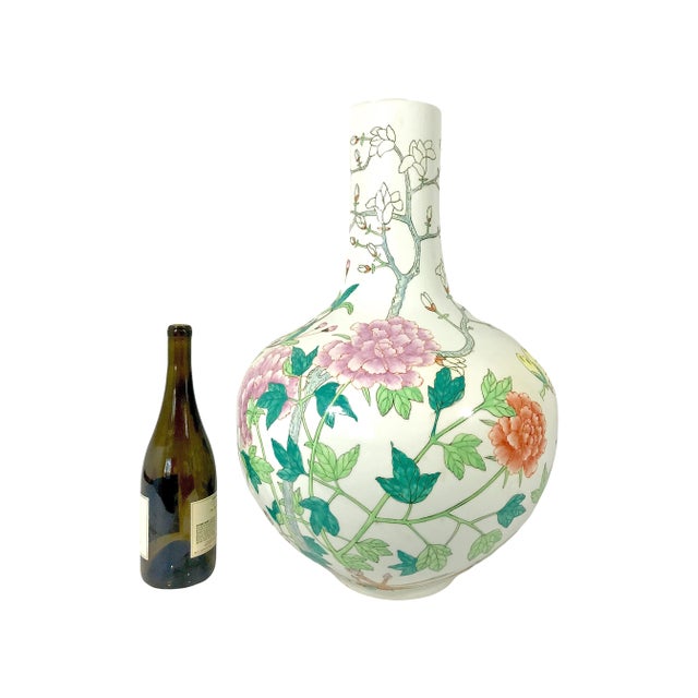 A very pretty Chinese white glazed porcelain vase with various purple, orange and yellow chrysanthemums and dahlias...
