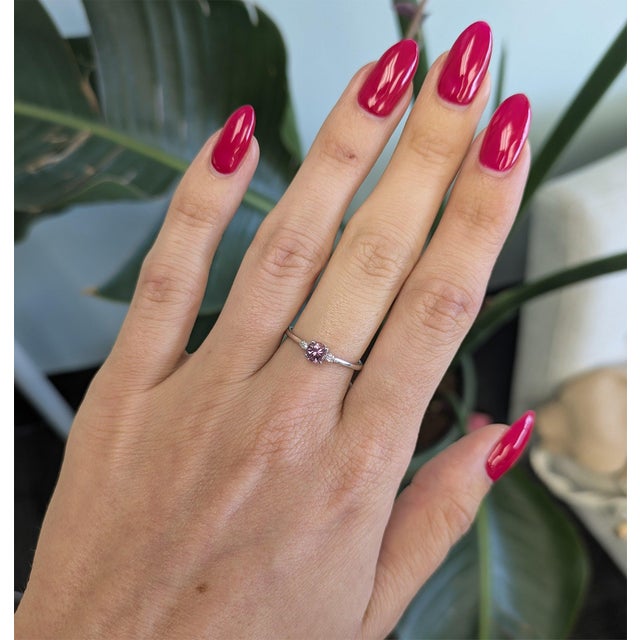 A natural purple spinel glows in a rich grape-purple at the center of this pared-back, minimal solid 14K white gold ring,...