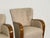 A refined pair of Danish lounge chairs dating to the 1940s, designed in an elegant Art Deco–influenced style. The chairs...