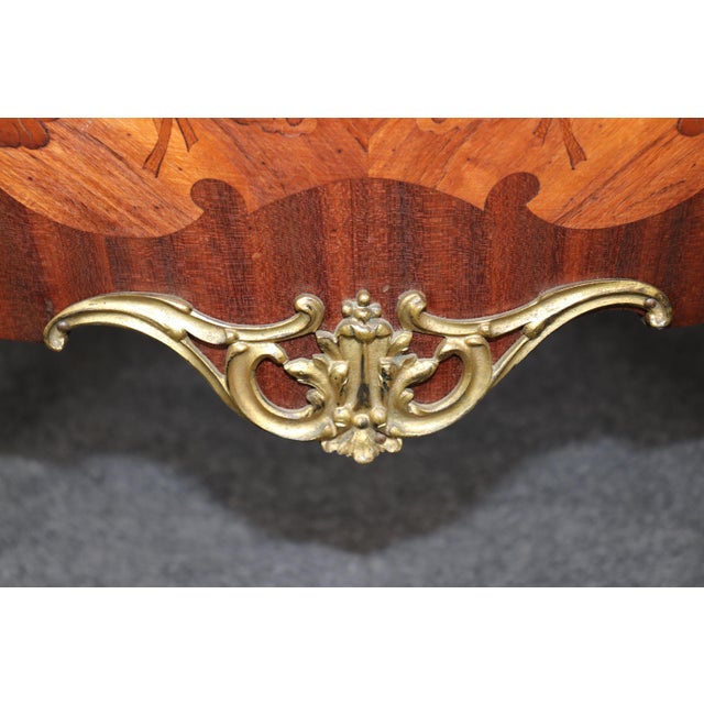 Magnificent, richly detailed, and unmistakably French, this antique Louis XV Style bronze ormolu mounted commode embodies...