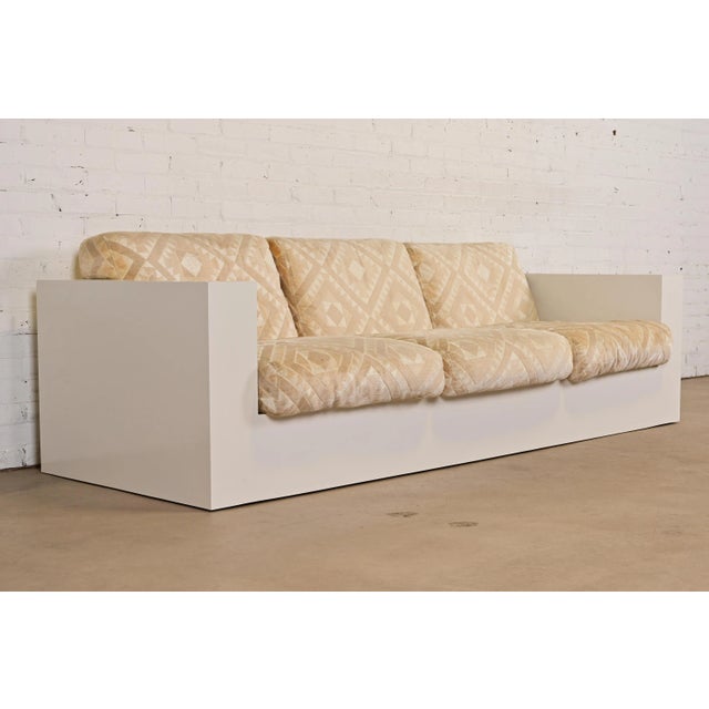 A gorgeous Mid-Century Modern tuxedo sofa By Milo Baughman for Thayer Coggin USA, Circa 1970s White laminate case, with...