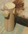 A sculptural vintage rustic bench featuring a hand-built solid log frame and an authentic cowhide sling seat. The...