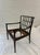 A handsome vintage Chippendale-style lounge chair featuring a pierced lattice back, sculptural open arms, and a richly...