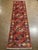 Vintage Hand-knotted Afghan tribal runner featuring six stepped geometric medallions set on a rust-red field with stylized...