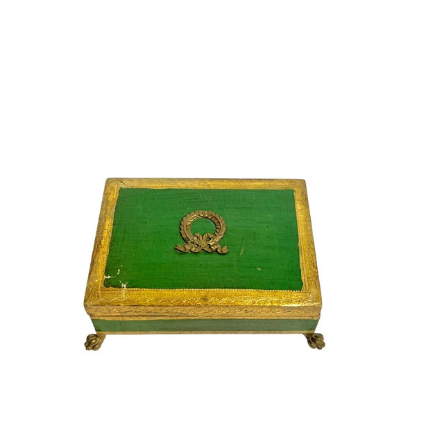 Vintage Italian wood box with gilt trim decoration and dark green center. 4 brass paw lion feet and brass laurel wreath in...