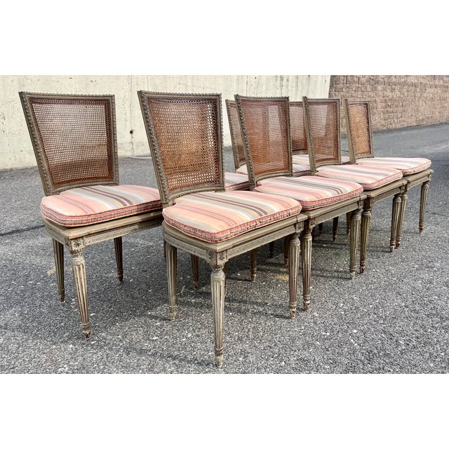 A fantastic set of custom 8 Louis XVI style dining chairs in the spirit of Maison Jansen. Old maker tags on underside of...