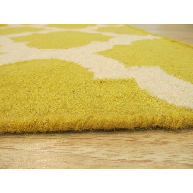 This yellow, gold, and orange wool rug features a flat weave construction consistent with Kilim styles. Handcrafted in...