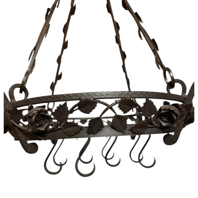 Georgeous wrought iron hanging pot rack featuring a circular base and rods decorated with hand forged scrolling iron roses...