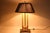 A striking antique French Empire style bouillotte lamp with the layered, collected character associated with classic Ralph...