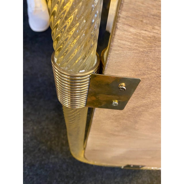 Oval gold “Torciglione” Murano Glass Wall Mirror. Scenographic wall mirror in brass elements with trasparent ando gold...