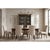Dark brown cabriole legs curve outward beneath cream upholstery, drawing a French outline around the seat and back. The...