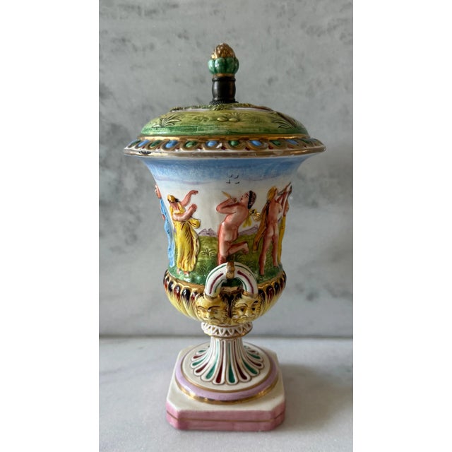 Vintage porcelain Capodimonte urn with hand painted Neoclassical relief made in Italy. Likely was originally made into a...